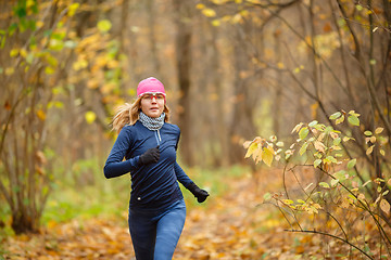Image showing Woman runner in the morning autumn park