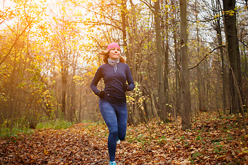 Image showing Young sportswoman running at park