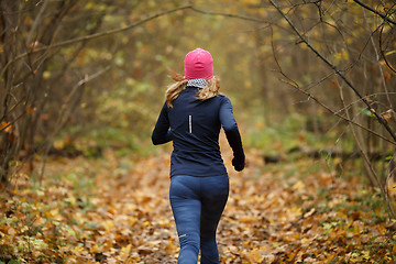 Image showing Blonde sportswoman among yellow Leavs