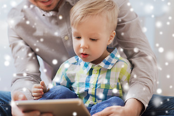 Image showing father and son with tablet pc playing at home