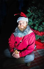 Image showing Man Dressed As Santa Sitting Under The Christmas Tree