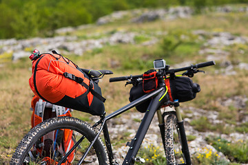 Image showing Bicycle with orange bags for travel