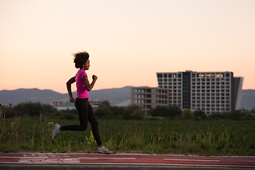 Image showing a young African American woman jogging outdoors