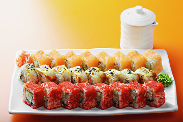 Image showing Different sushi rolls and saucer