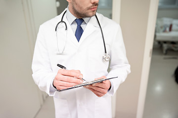 Image showing close up of doctor with clipboard at hospital