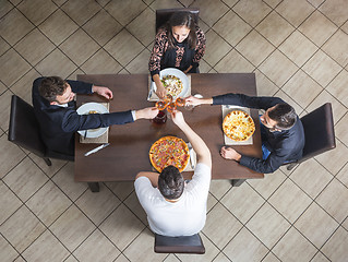 Image showing Friends Clinking Wine Glasses at a Restaurant