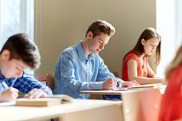 Image showing group of students with books writing school test