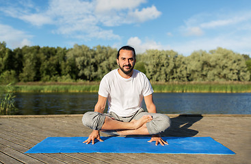 Image showing man making yoga in scale pose outdoors