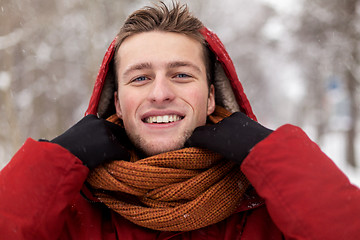 Image showing happy man in winter jacket and scarf outdoors