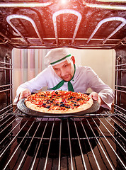 Image showing Chef cooking pizza in the oven.