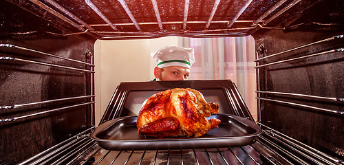 Image showing Cooking chicken in the oven.