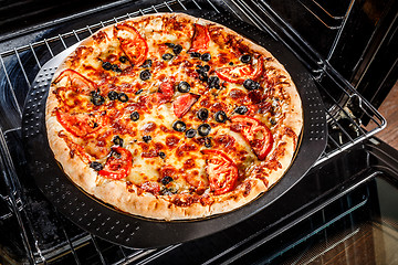 Image showing Appetizing pizza in the oven.