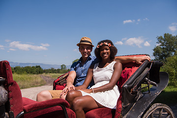 Image showing multiethnic couple sitting in a horse carriage