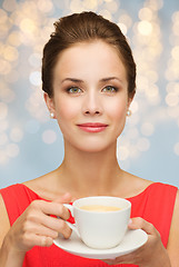 Image showing woman in red with cup of coffee over lights
