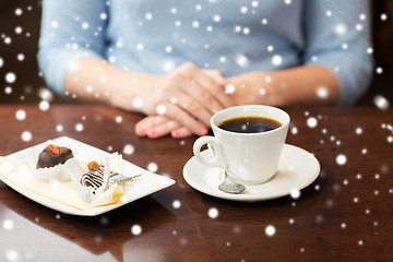 Image showing close up of woman hands with coffee and dessert