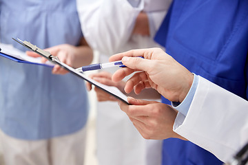 Image showing close up of doctors with clipboard at hospital