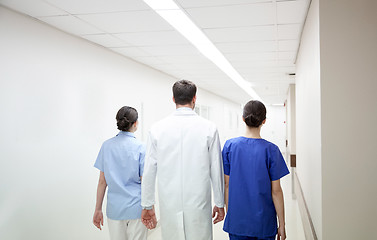 Image showing group of medics or doctors walking along hospital