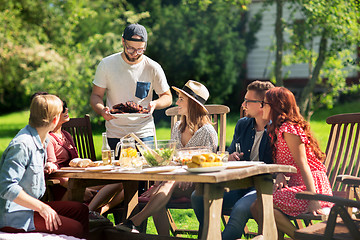 Image showing happy friends having dinner at summer garden party