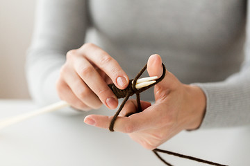 Image showing close up of hands knitting with needles and yarn