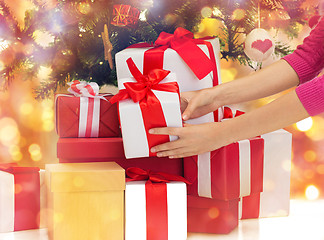 Image showing close up of woman with gifts and christmas tree