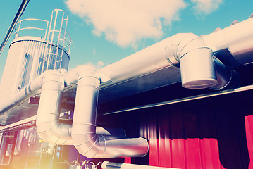 Image showing Industrial zone, Steel pipelines and valves against blue sky