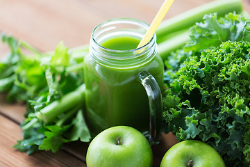 Image showing close up of jug with green juice and vegetables