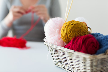 Image showing woman, basket with knitting needles and yarn balls