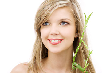 Image showing blue-eyed blonde with bamboo