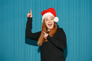 Image showing Surprised christmas girl wearing a santa hat