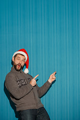 Image showing Smiling christmas man wearing a santa hat