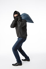 Image showing Thief with bag on shoulder