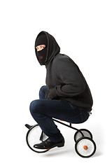 Image showing Burglar in mask on bicycle