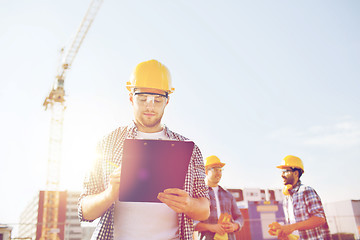 Image showing group of builders in hardhats outdoors