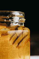 Image showing Close up of honey stick in jar