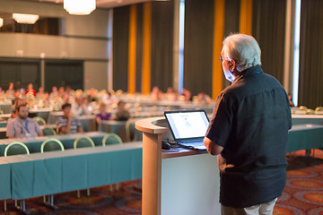 Image showing Senior public speaker giving talk at scientific conference.