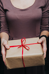 Image showing Crop hands holding wrapped present