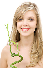 Image showing blue-eyed blonde with bamboo