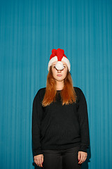 Image showing Funny christmas girl wearing a santa hat