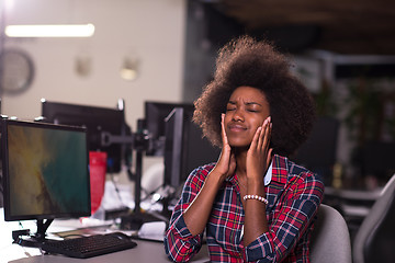Image showing a young African American woman feels tired in the modern office