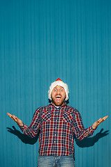 Image showing Surprised christmas man wearing a santa hat