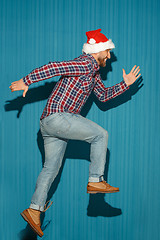 Image showing The running christmas man wearing a santa hat