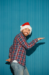 Image showing Surprised christmas man wearing a santa hat