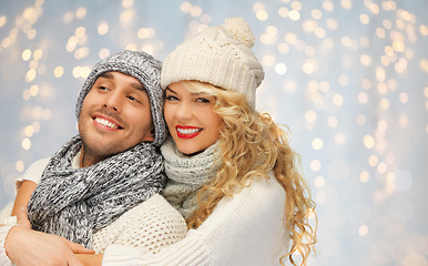 Image showing happy family couple in winter clothes hugging