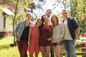 Image showing happy teenage friends hugging at summer garden