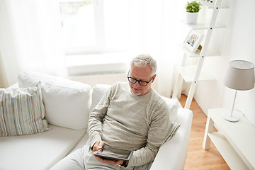 Image showing senior man with tablet pc at home