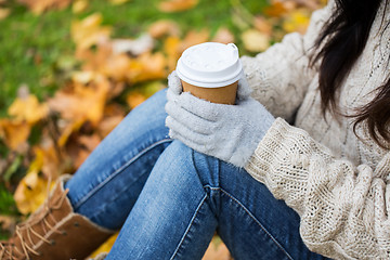 Image showing close up of woman drinking coffee in autumn park