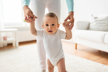 Image showing happy baby learning to walk with mother help