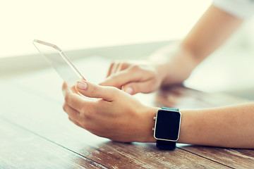 Image showing close up of hands with smart phone and watch