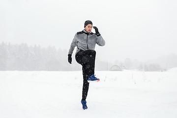 Image showing man exercising and warmig up in winter outdoors