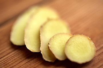 Image showing close up of ginger root on wooden table